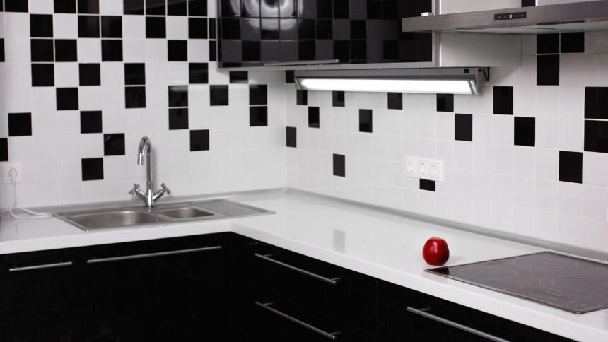 Foto mostra um azulejo de cozinha com pia e bancada.