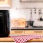 Imagem de uma air fryer em cima de uma bancada da cozinha