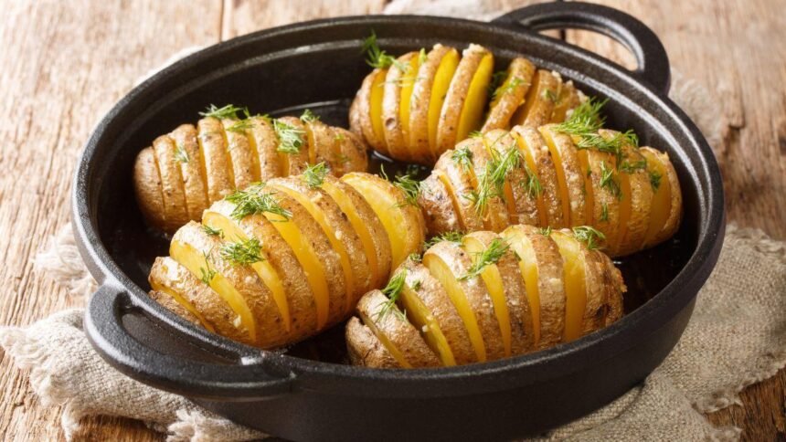 Imagem de batatas assadas em uma assadeira preta redonda